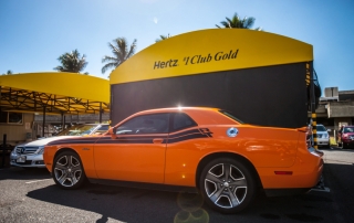 Orange Dodge Challenger parked near Herzt rental office