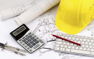an architect's blueprint with construction helmet of a construction worker. symbolic photo for funding and planning of a new home.