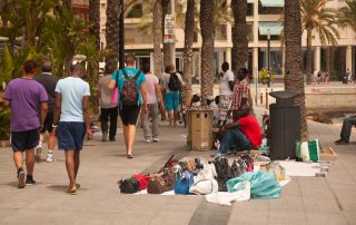 Torrevieja, Spain - July 26, 2012: Street scene with vendors and walkers on a windy day with scirocco winds, bringing red sand from the Sahara desert. Torrevieja, Costa Blanca, Spain on July 26, 2012.