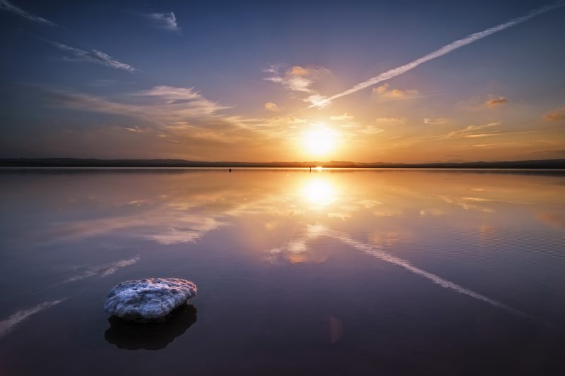 Beautiful salt lake landscape, Golden sunset and reflections over de salt marsh, Las salinas, Torrevieja, Spain, Parque Natural de las Lagunas de La Mata y Torrevieja.